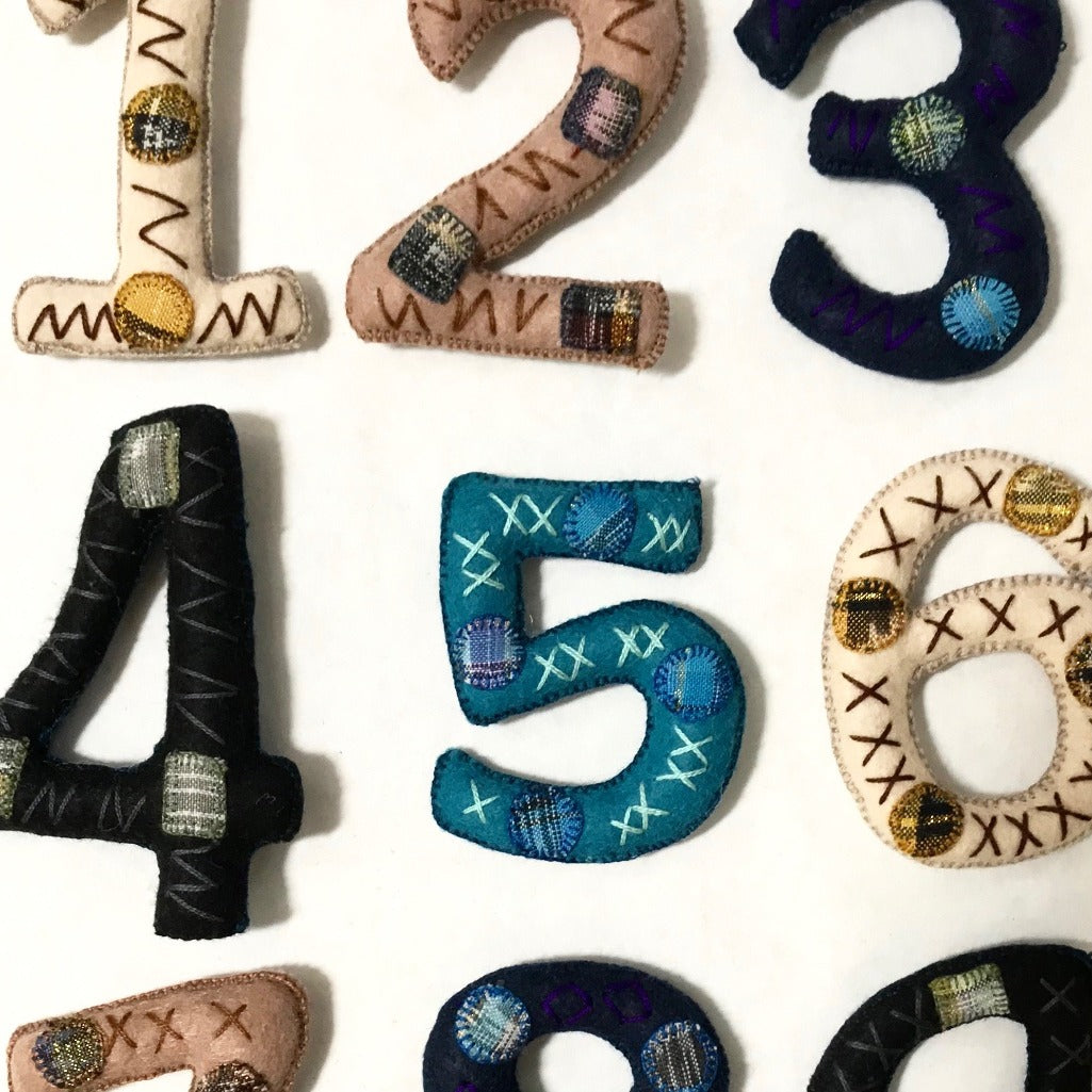 Set of cloth numbers 0 to 9 made of embroidered recycled traditional Maya textiles by Living Threads Co.
