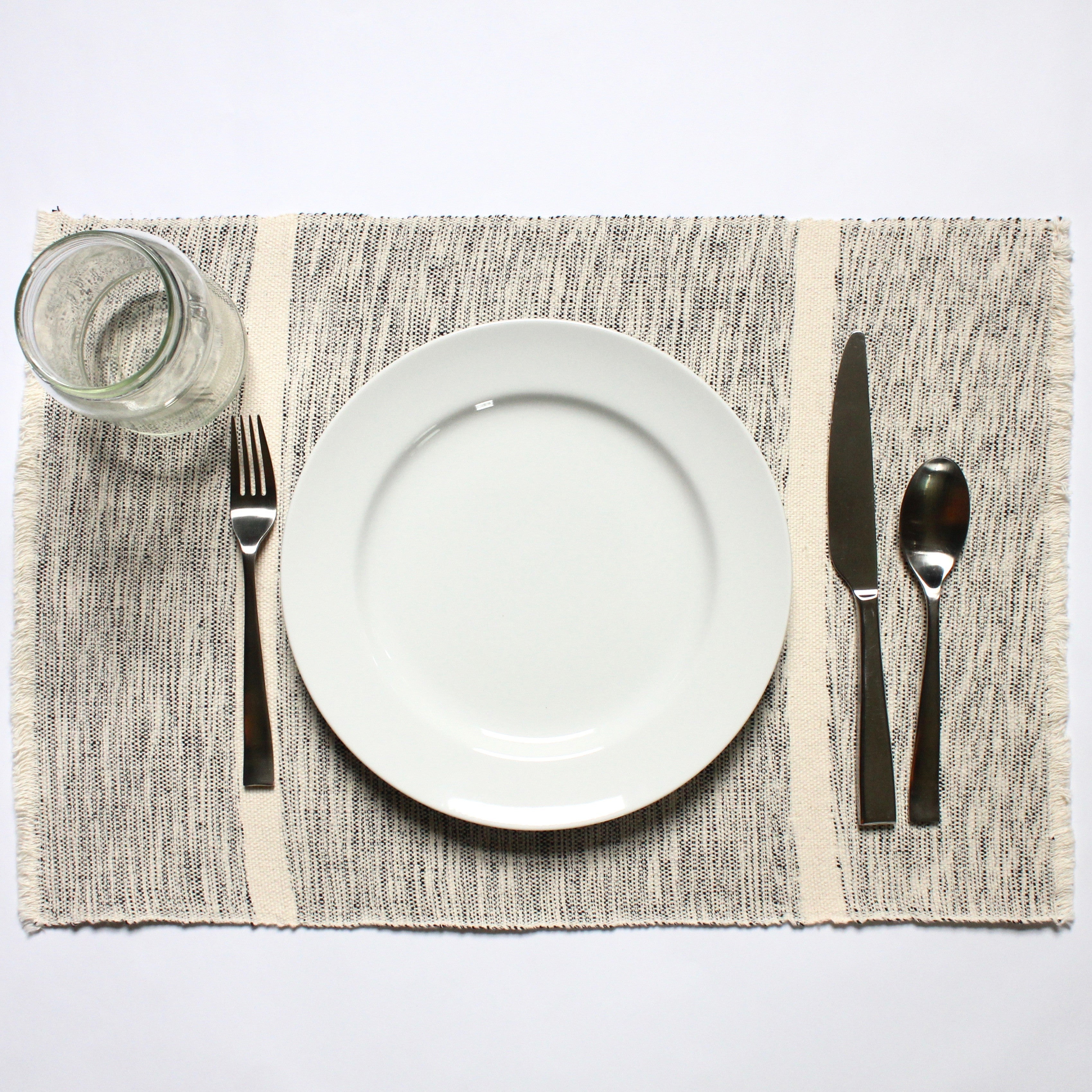 INDI mixed grey and natural striped placemats woven by hand with 100% ecologically dyed cotton by Living Threads Co.