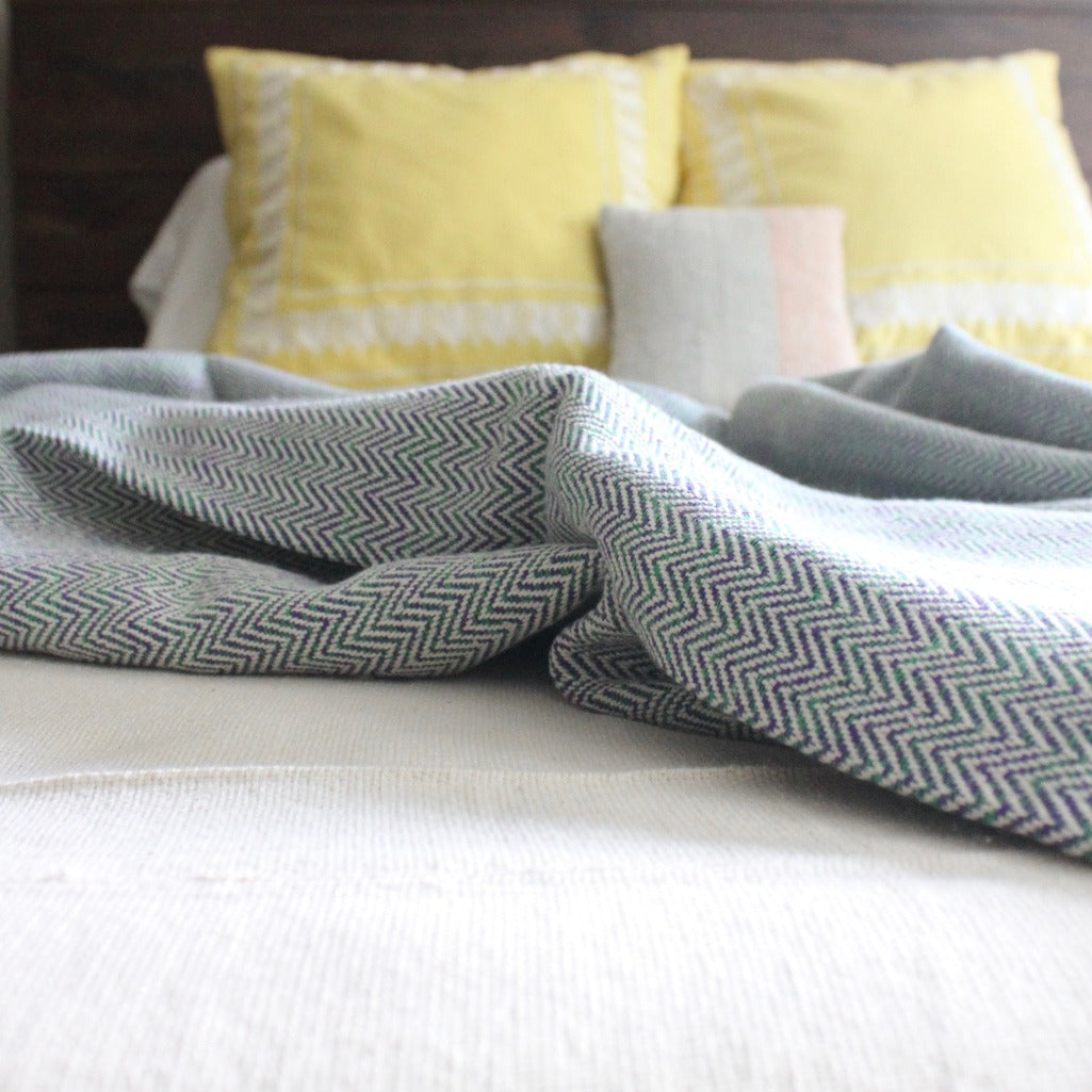 Living Threads Co. MADERA hand woven herringbone cotton throw in purple and green
