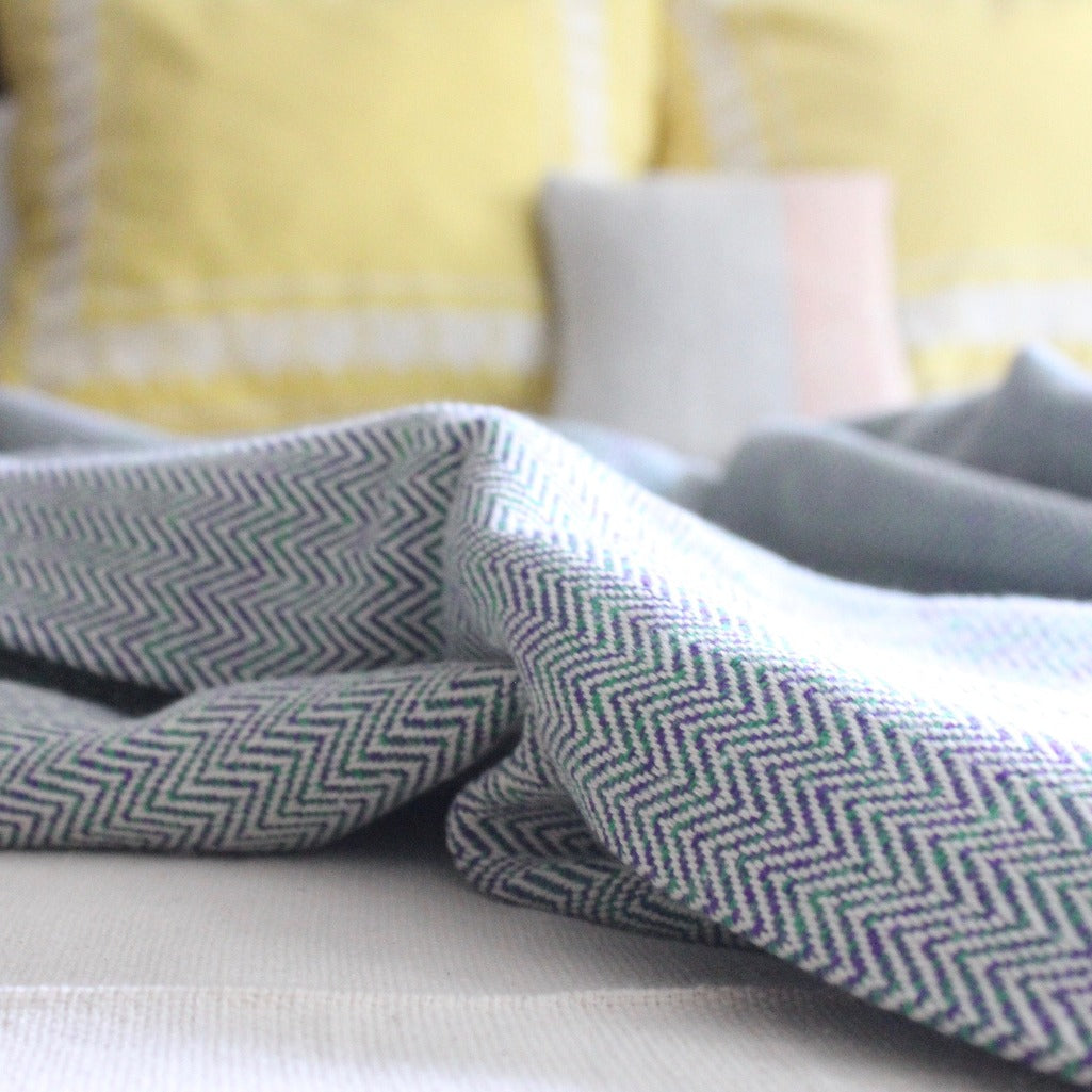 Eco-dyed purple and green MADERA handwoven herringbone cotton throw by Living Threads Co. artisans.