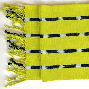 Chartreuse TIPICA table runner in naturally dyed cotton, handwoven by partner artisans in Guatemala inspired by traditional Ikat designs. 