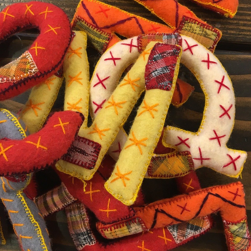 Handwoven alphabet set in Sunshine colors by Living Threads Co. artisans in Guatemala.