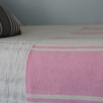 Handwoven AUDAZ 100% cotton blanket by Living Threads Co. in Pink