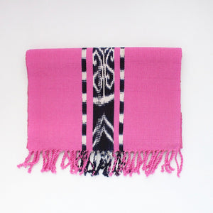 Ikat TAY table runner in Pink, naturally dyed and handwoven by Guatemalan partner artisans on a traditional Mayan backstrap loom.