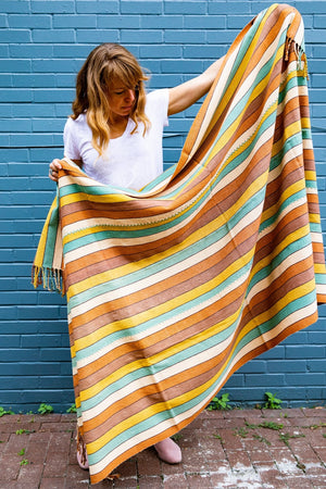 JUANA hand woven naturally dyed Living Threads Co. blanket in multicolored striped pattern.