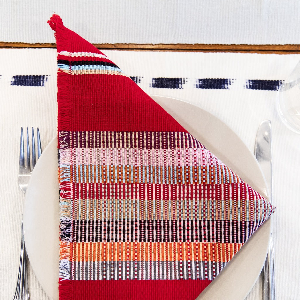 Handwoven KUS Napkins by Living Threads Co. naturally dyed in red and woven by Guatemalan artisans.