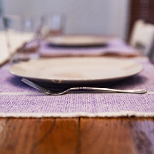 Purple handwoven INDI placemats by Living Threads Co. artisans in Nicaragua.