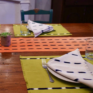Table runners and napkins made with naturally dyed cotton by Guatemalan artisans