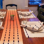 Artisan handcrafted ANAH table runner. Handwoven in Guatemalan by Living Threads Co. artisans using traditional techniques and natural dye. ANAH table runner in orange and natural 