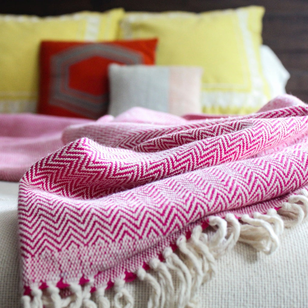 Fuchsia handwoven herringbone cotton blanket by Living Threads Co. Nicaraguan artisans.