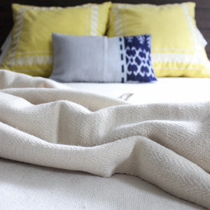 Extremely soft handwoven artisanal herringbone blanket in natural by Living Threads Co. 