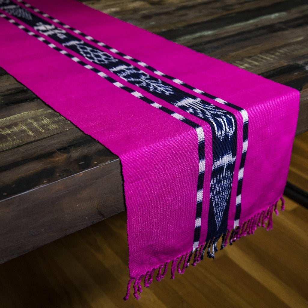 Handwoven naturally dyed TAY Ikat table runner in Pink made by Guatemalan partner artisans on a traditional Mayan backstrap loom.